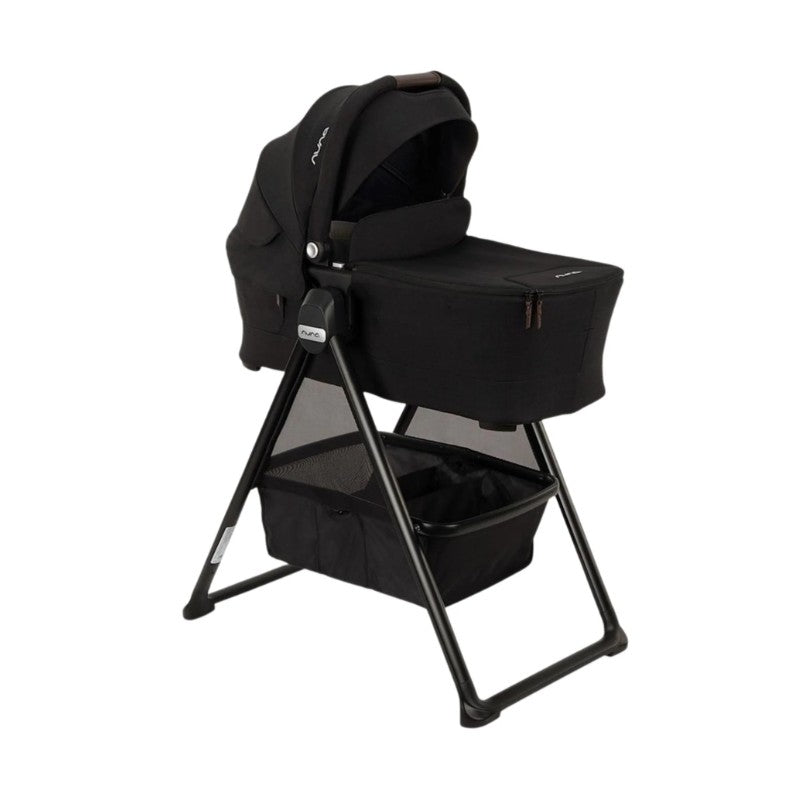 Nuna Swiv Stroller with a black bassinet on a stand, featuring a zippered compartment and a lower storage basket.