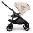 Nuna Swiv stroller in Chai/Caviar color, featuring a lightweight frame, adjustable canopy, and spacious storage basket.