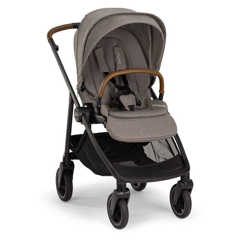 Nuna Swiv stroller in granite with caviar accents, featuring a tan handle and safety harness, ready for use.