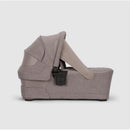 Nuna SWIV & TRIV Series Bassinet in Umber, featuring a cozy design, adjustable canopy, and secure harness system.