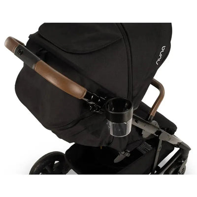 Nuna TAVO™ Series Cup Holder attached to a black stroller with a brown handle, designed for holding drinks.