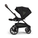 Nuna Triv LX stroller in Caviar color with a large canopy, spacious seat, and four wheels.