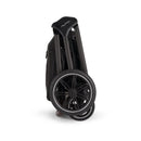 Nuna Triv Lx stroller in a folded position, showcasing its compact design and durable wheels.