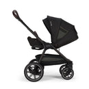 Nuna Triv Lx stroller in black with a detachable infant car seat, showcasing a stylish modern design and adjustable features.