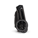 Nuna Triv Lx travel system bundle in caviar color, showcasing the compactly folded stroller with visible wheels and handle.