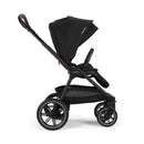 Nuna Triv Lx stroller in caviar color, featuring a large canopy, adjustable handle, and a lower storage basket.