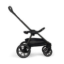 Nuna Triv Lx stroller in caviar color with a black fabric seat and large wheels, designed for travel systems.