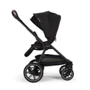 Nuna Triv LX stroller in black with a large canopy, adjustable handle, and spacious storage basket underneath.