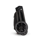 Nuna Triv Lx stroller folded with carbon fiber handles and black wheels, showcasing compact design for easy storage.