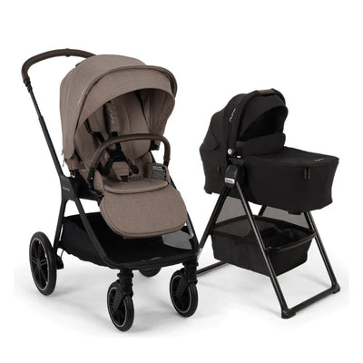 Nuna Triv Lx stroller in cedar color with a matching triv bassinet on a stand in black, showcasing a modern, sleek design.