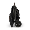 Nuna Trvl 360 Compact Stroller in Caviar color, folded and showcasing its sleek design and compact profile.