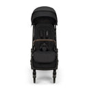 Nuna Trvl 360 compact stroller in Caviar color, featuring a padded seat, adjustable canopy, and a brown handlebar.
