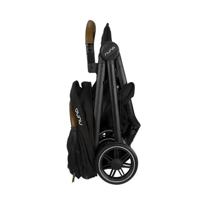 Nuna TRVL™ Stroller in Caviar color, folded for travel, featuring sleek black frame and brown handle accents.