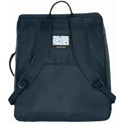 Nuna TRVL™ Transport Bag in Indigo features padded straps, a carry handle, and a transparent ID pocket.