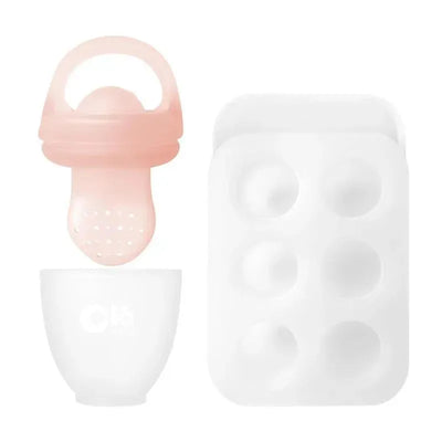 Silicone fresh fruit feeder in coral color, paired with a white feeding bowl and a popsicle mold with six cavities.