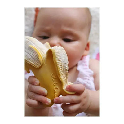 Chewable toy Ana Banana by Oli & Carol held by a baby, featuring a textured yellow banana design.