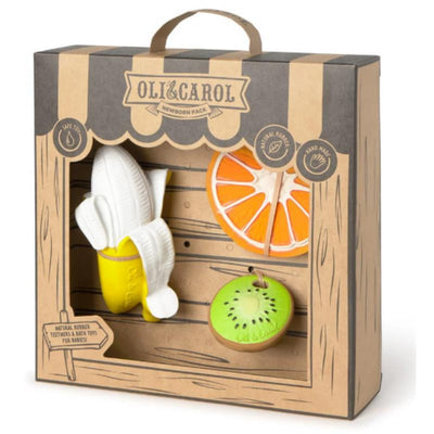 Newborn gift set from Oli & Carol featuring natural rubber teething toys: a banana, orange, and kiwi, packaged attractively.