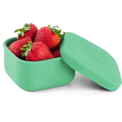 Green OmieBox container with lid holding fresh strawberries inside.