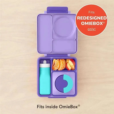 Leak-proof teal silicone water bottle beside a purple lunchbox containing fruit and a snack compartment.
