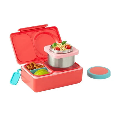 OmieBox bento box in cherry pink, featuring compartments for pasta with tomatoes, pretzels, and apple slices.