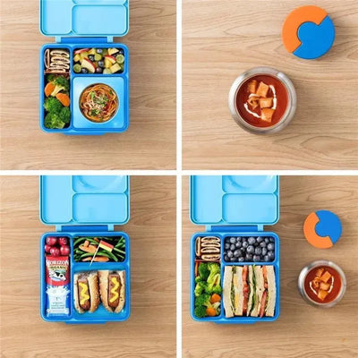Insulated blue OmieBox bento box filled with colorful food items, including fruits, vegetables, and sandwiches, accompanied by a thermos.