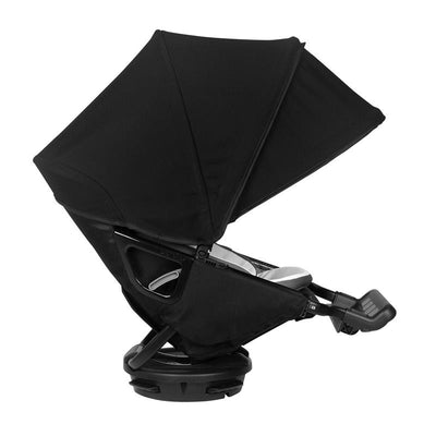 Orbit Baby G5/X5 Helix+ Seat in Melange Flax, featuring a black canopy and seat, positioned for user engagement.