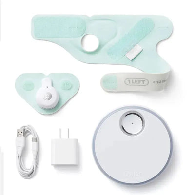 Mint-colored Owlet Dream Sock Monitor components including sensor, sock patches, charger, and USB cable.