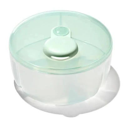 OXO Tot Formula Dispenser in opal color, featuring a clear body and mint green lid, designed for convenient formula storage.