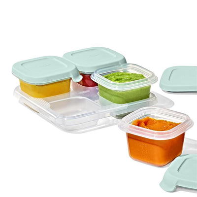 Oxo Tot Silicone Baby Blocks food storage containers with colorful purees in four 4 oz cups and lids on a clear tray.