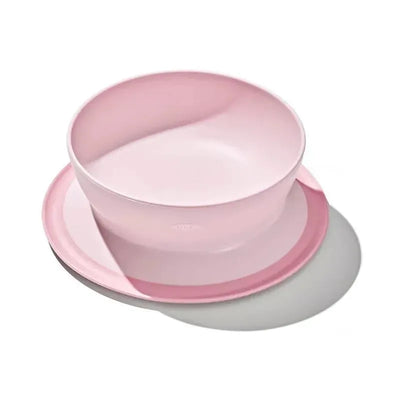 Oxo Tot Stick and Stay Suction Bowl in Blossom, featuring a soft pink color and a secure suction base for stability.