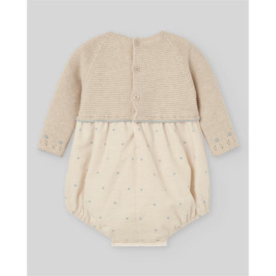 Light brown and chalk blue knit newborn romper featuring a buttoned back and decorative blue dots on the lower half.