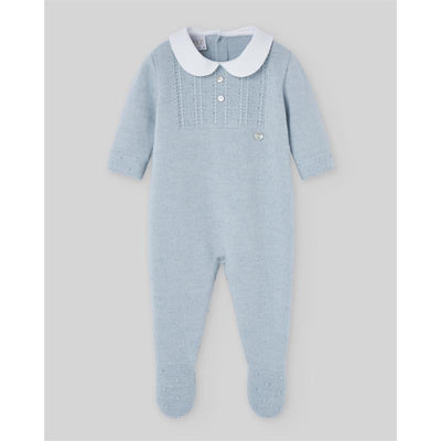 Knit newborn romper in chalk blue with a white collar, button placket, and footed design.
