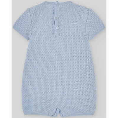 Knit newborn romper in sky blue with a textured pattern and button closure at the back.