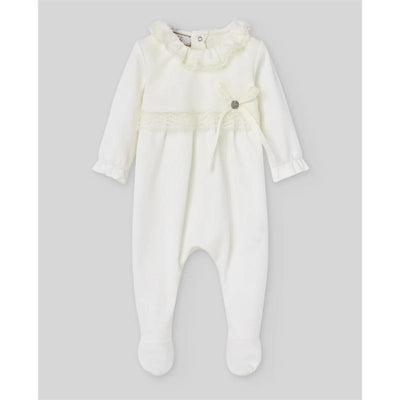 Cream knit newborn romper with ruffled neckline, lace detail, and a bow accent. Perfect for infants.