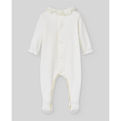 Cream-colored knit newborn romper by Paz Rodriguez with a ruffled collar and button closure, featuring long sleeves and footed design.