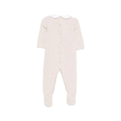 Knit newborn romper in linen and white with long sleeves, a white collar, and button closure on the back.