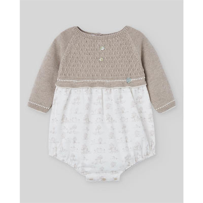 Knit newborn romper in light brown with a textured upper, three buttons, and a printed white bottom featuring playful designs.