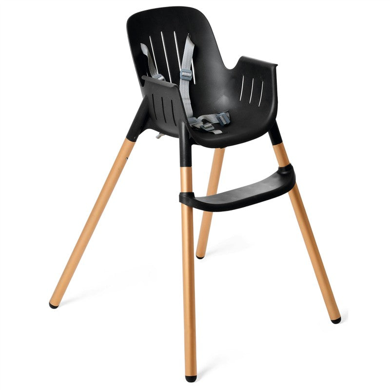 High chair in black with gold legs, featuring a safety harness and a sleek, modern design.