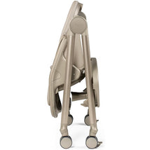 Peg-Perego Living Grow high chair and recliner in Space Sand color, shown in a folded position with wheels for mobility.