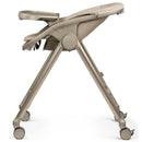 Peg-Perego Living Grow folding high chair and recliner in Space Sand color, featuring a compact design with adjustable seat height.