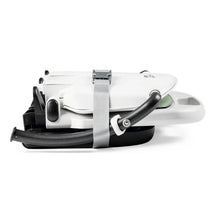 Peg Rialto Booster High Chair in Ice, shown in a folded position with a strap for secure storage.