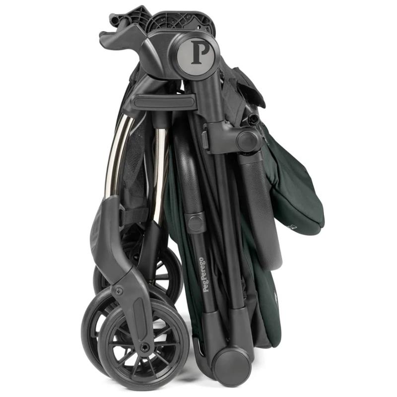 Peg Volo Compact Stroller in sage green, folded for storage, showcasing its wheels and metal frame.
