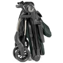 Peg Volo Compact Stroller in sage green, folded for storage, showcasing its wheels and metal frame.