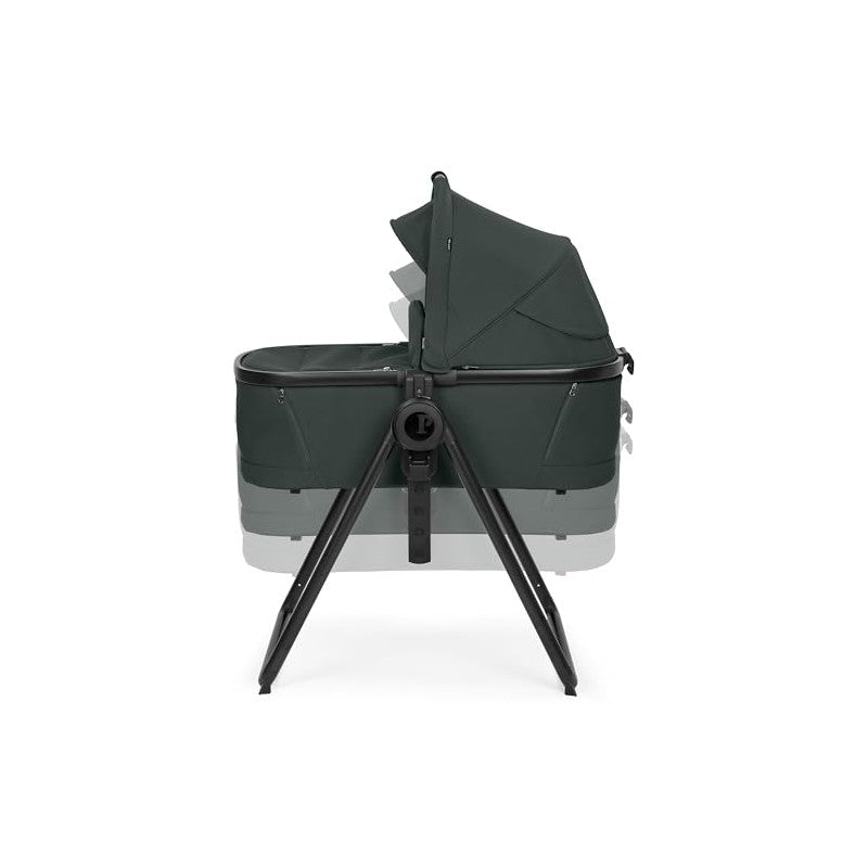 Sage green Peg Perego Ypsi Bassinet w/Stand by Me, featuring a sturdy metal frame and adjustable canopy.