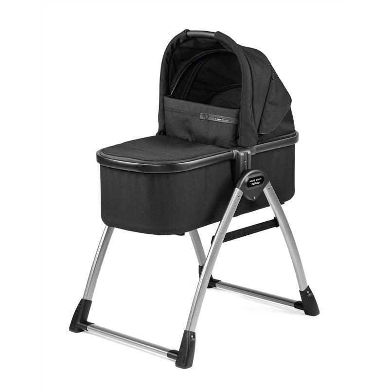 Peg Perego Ypsi Bassinet w/Stand by Me 2025 in True Black, featuring a padded mattress and a sleek metal frame.