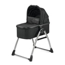 Peg Perego Ypsi Bassinet w/Stand by Me 2025 in True Black, featuring a padded mattress and a sleek metal frame.