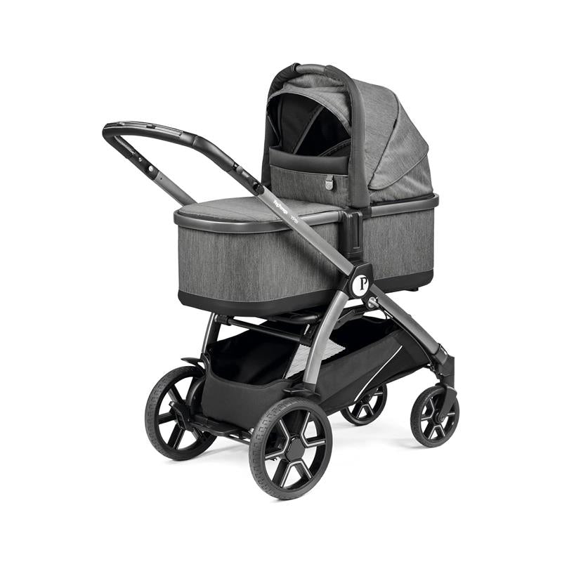 Peg Perego Ypsi Travel System in Vanilla Blend features a gray stroller frame with a bassinet on top, sleek black wheels, and a storage basket underneath.