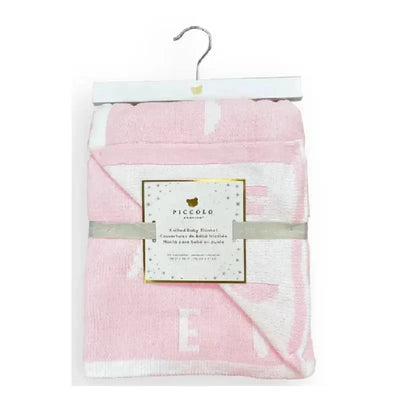 Feather chenille stroller blanket by Piccolo Bambino, pink with white accents, hanging on a wooden hanger.