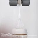 Silicone nipple from Pigeon for infants 3+ months, demonstrating its flexibility with a droplet forming at the tip.