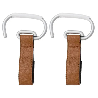Leather stroller hooks in camel color, featuring aluminum carabiners for securing bags to strollers.